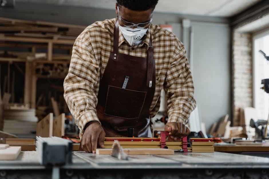 Portrait of a craftsman focused on precise woodcutting using tools in a workshop.