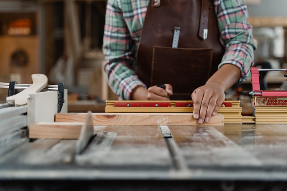 Close-up of a carpenter measuring wood on a workbench, showcasing craftsmanship and precision.